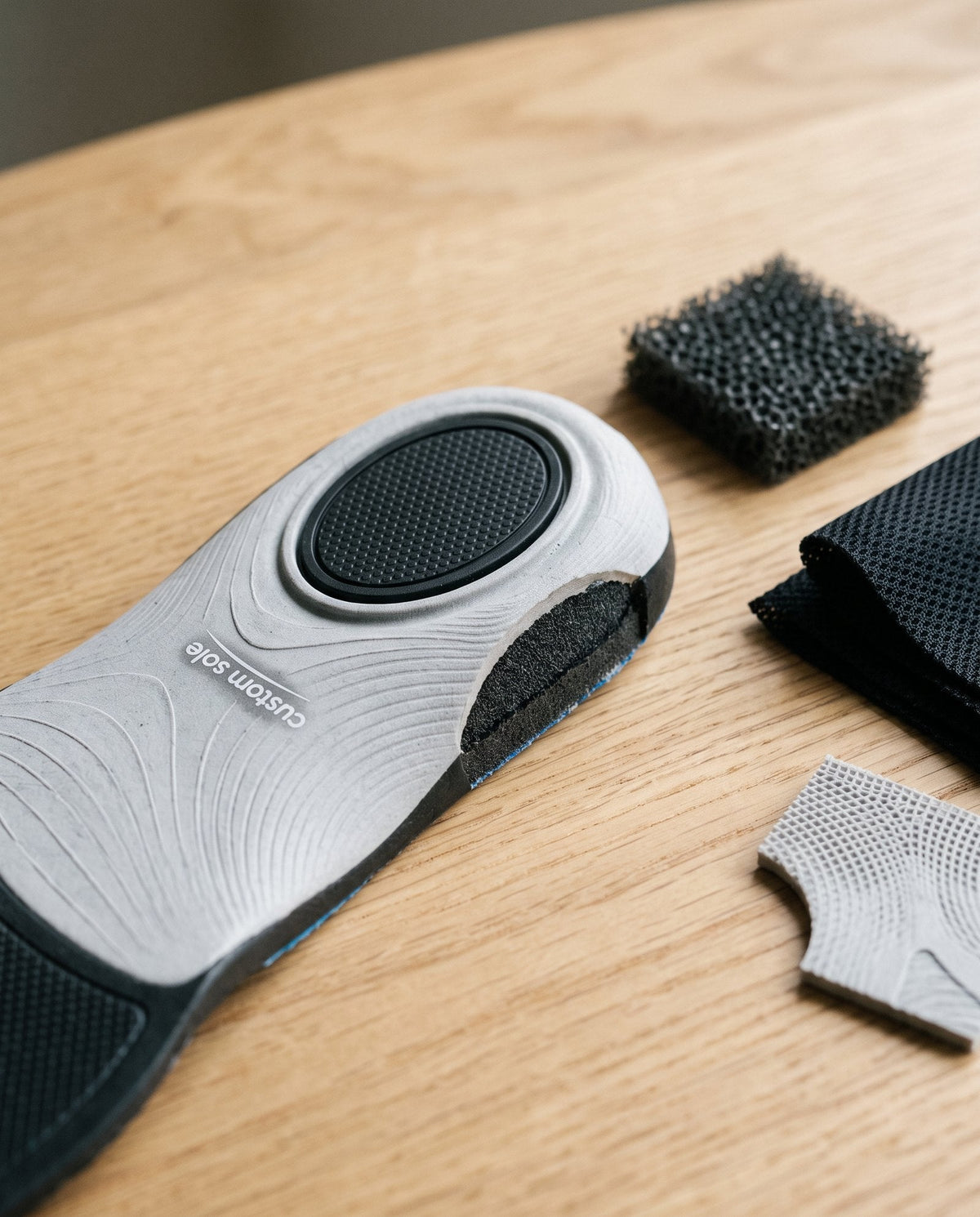 Insole materials laid out on a workbench, including the printed shell and soft layers