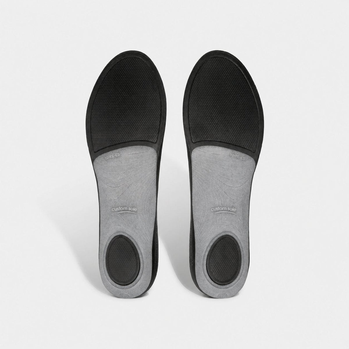 Underside of CustomSole full-length insoles: black base with grey arch shell and cushioned heel and forefoot pads