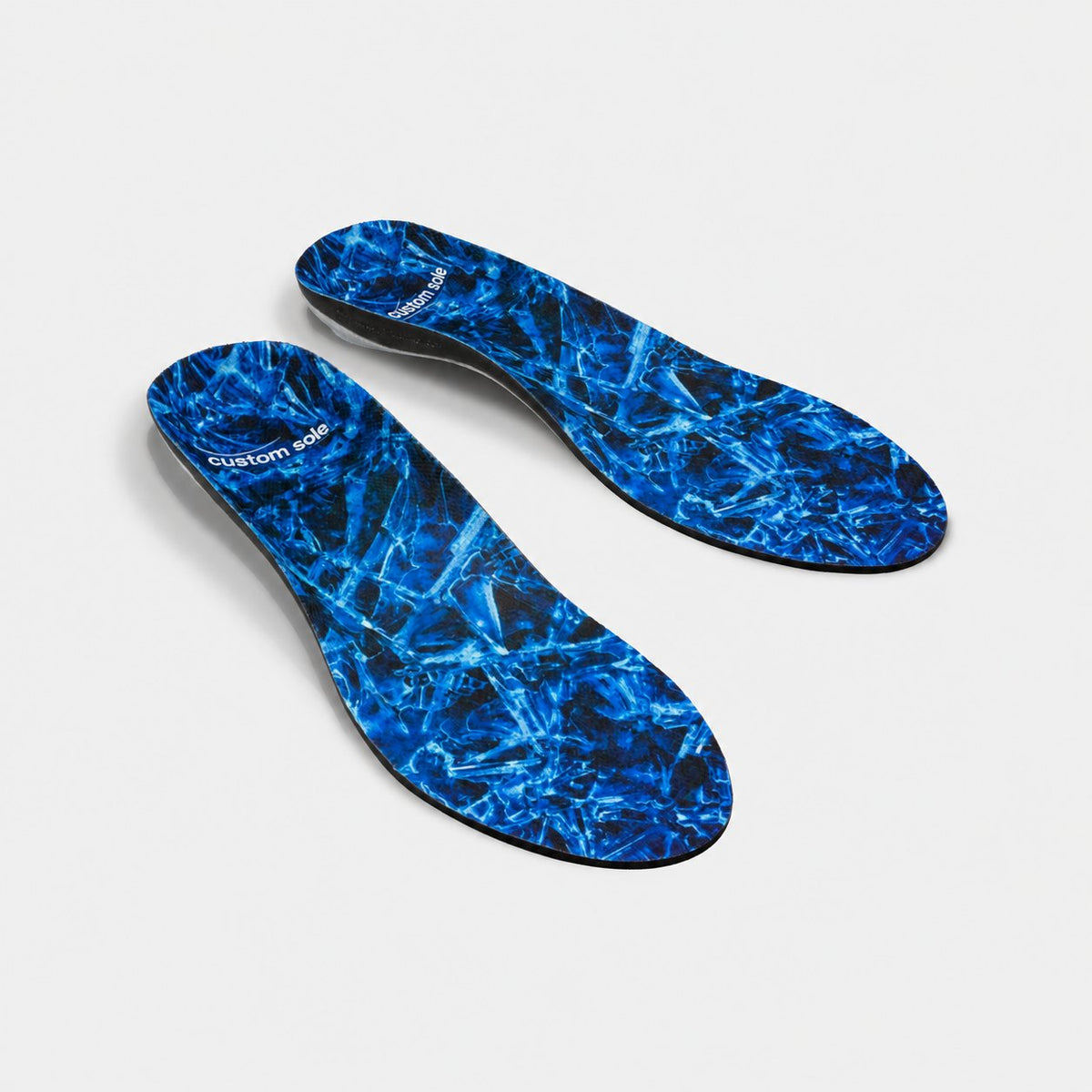 Glacier custom insoles shown at an angle to reveal the contoured arch and deep heel cup