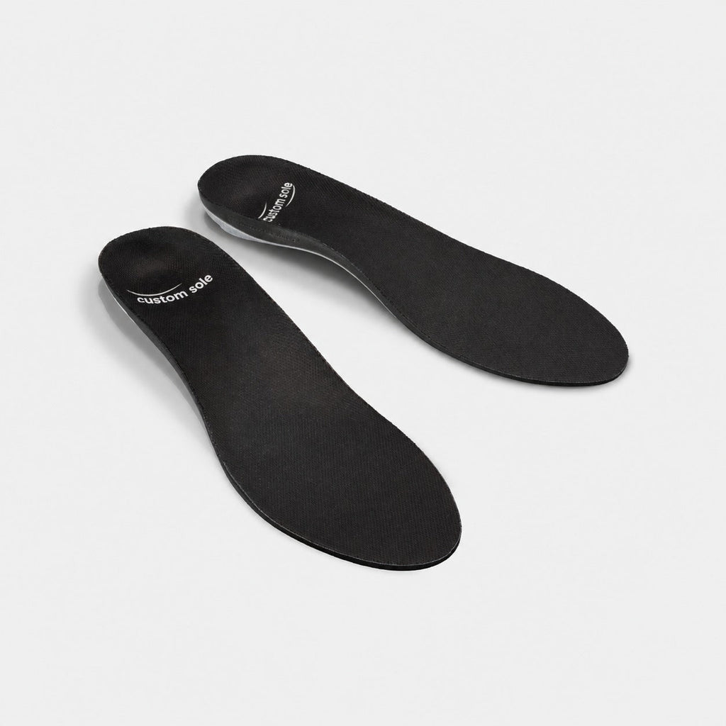 Obsidian custom insoles shown at an angle to reveal the contoured arch and deep heel cup