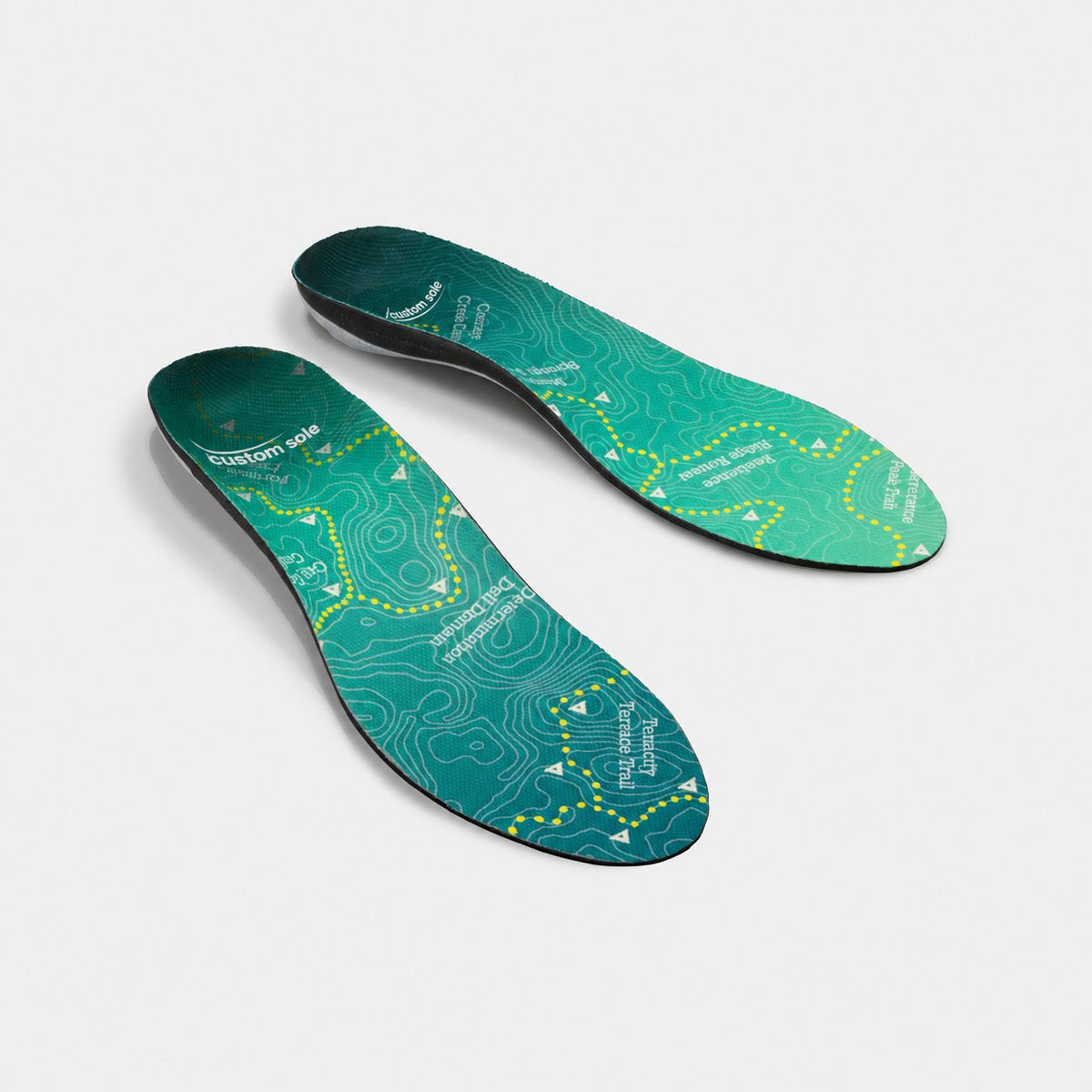 Topo Trek custom insoles shown at an angle to reveal the contoured arch and deep heel cup